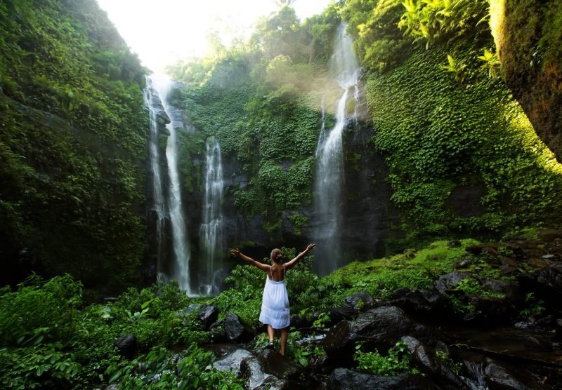Woman,In,White,Dress,At,The,Sekumpul,Waterfalls,In,Jungles