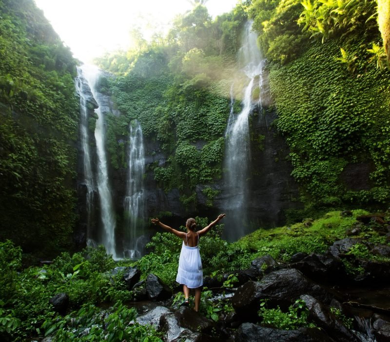 Woman,In,White,Dress,At,The,Sekumpul,Waterfalls,In,Jungles