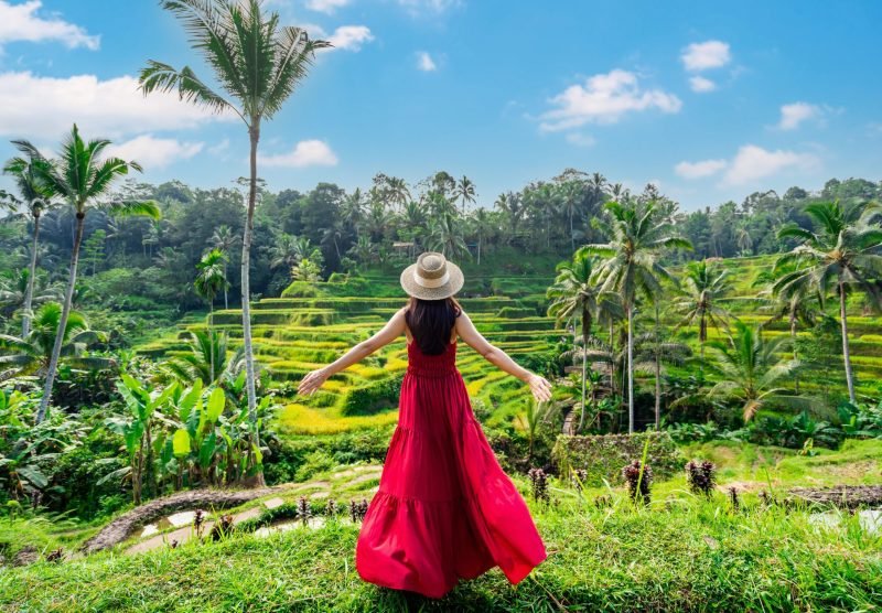 Young,Female,Tourist,In,Red,Dress,Looking,At,The,Beautiful