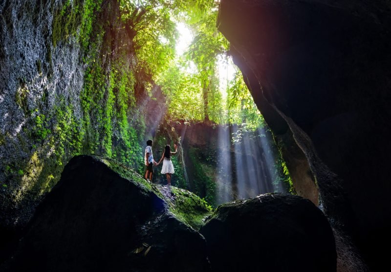 Young,Couple,Tourism,With,Rays,Of,Light,Enjoying,Tukad,Cepung