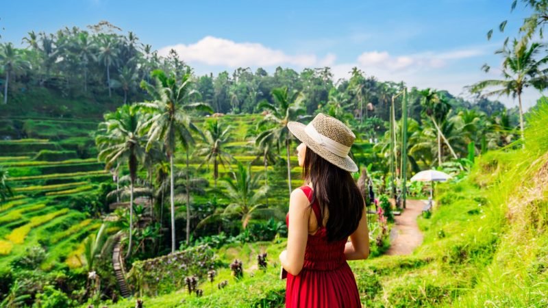 Young,Female,Tourist,In,Red,Dress,Looking,At,The,Beautiful