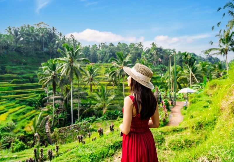 Young,Female,Tourist,In,Red,Dress,Looking,At,The,Beautiful