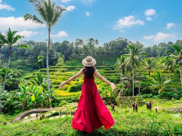 Young,Female,Tourist,In,Red,Dress,Looking,At,The,Beautiful